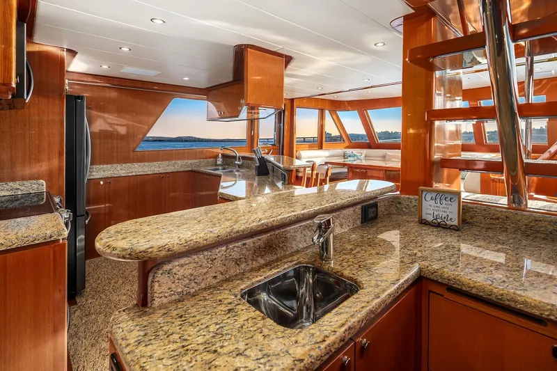 Slide: The Image of Luxurious 2014 Hampton 720 Skylounge LRC yacht interior with granite countertops and scenic water views. - 18