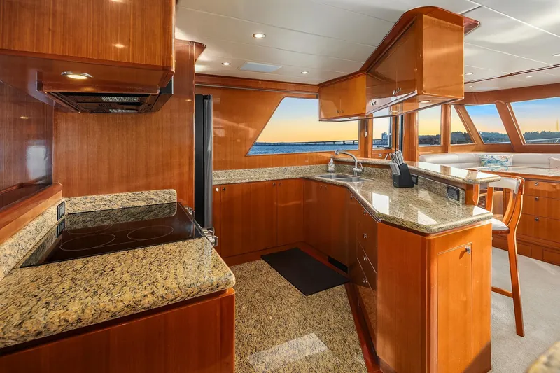 Slide: The Image of Luxurious 2014 Hampton 720 Skylounge LRC yacht kitchen with granite countertops and modern appliances. - 19