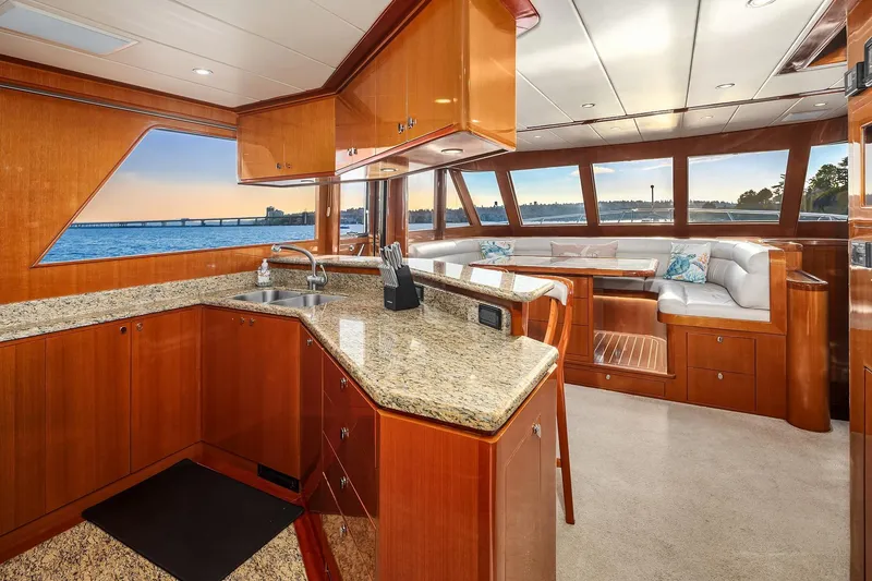Slide: The Image of Luxurious 2014 Hampton 720 Skylounge LRC yacht interior with modern kitchen and elegant wood finishes. - 20