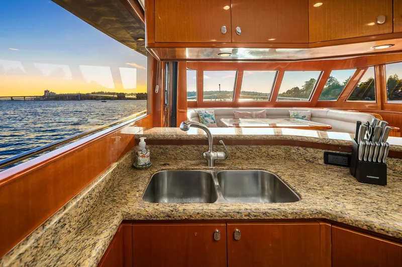 Slide: The Image of Luxurious interior of 2014 Hampton 720 Skylounge LRC yacht with elegant wood finishes and ocean view. - 21