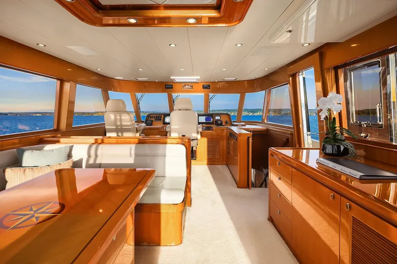 Slide: The Image of Helm of 2014 Hampton 720 Skylounge LRC yacht with navigation screens and wooden steering wheel. - 31