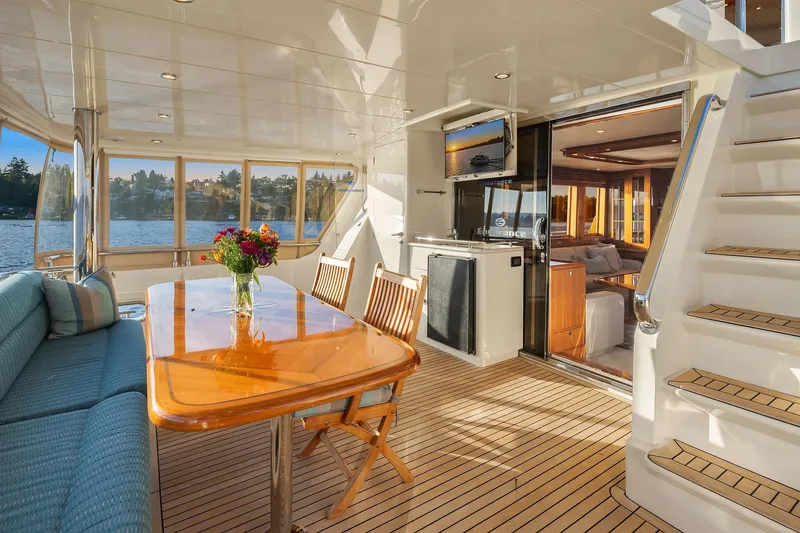Slide: The Image of 2014 Hampton 720 Skylounge LRC yacht deck with ocean view at sunset. - 77