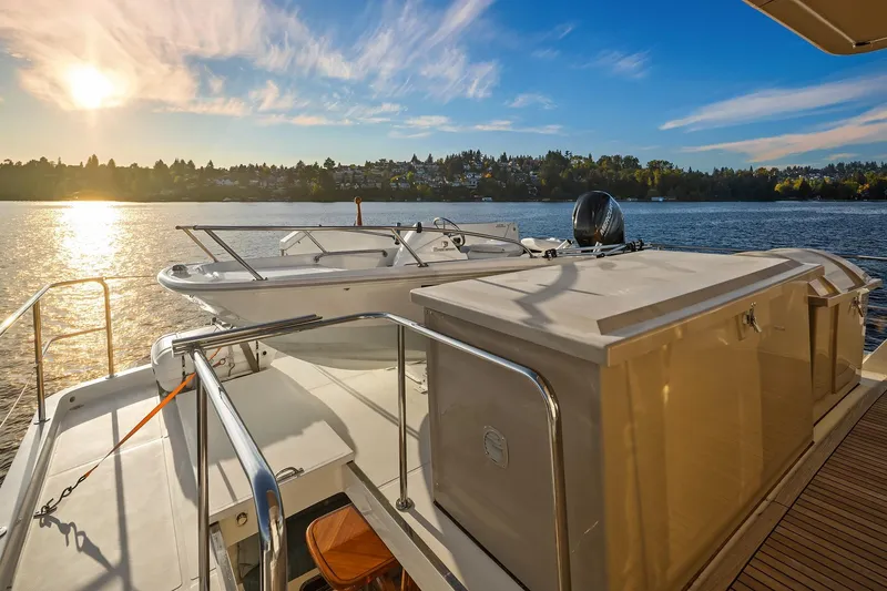 Slide: The Image of 2014 Hampton 720 Skylounge LRC yacht cruising on a serene lake under a clear blue sky. - 79