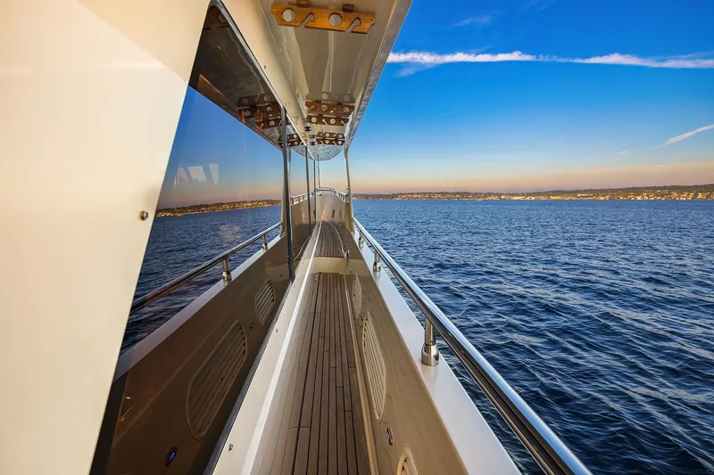 Slide: The Image of Luxurious 2014 Hampton 720 Skylounge LRC yacht cruising on serene waters at sunset. - 81