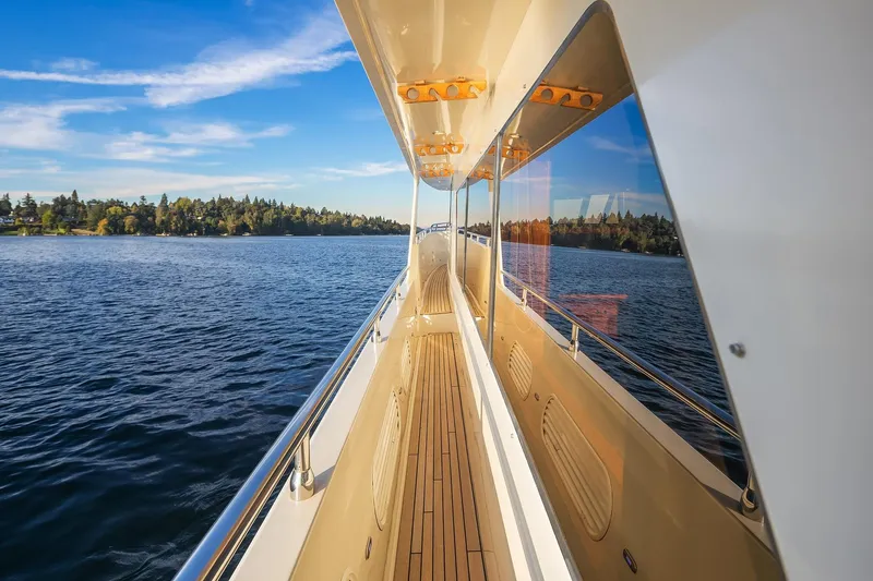 Slide: The Image of Luxurious 2014 Hampton 720 Skylounge LRC yacht at sunset, featuring elegant deck and ocean view. - 82