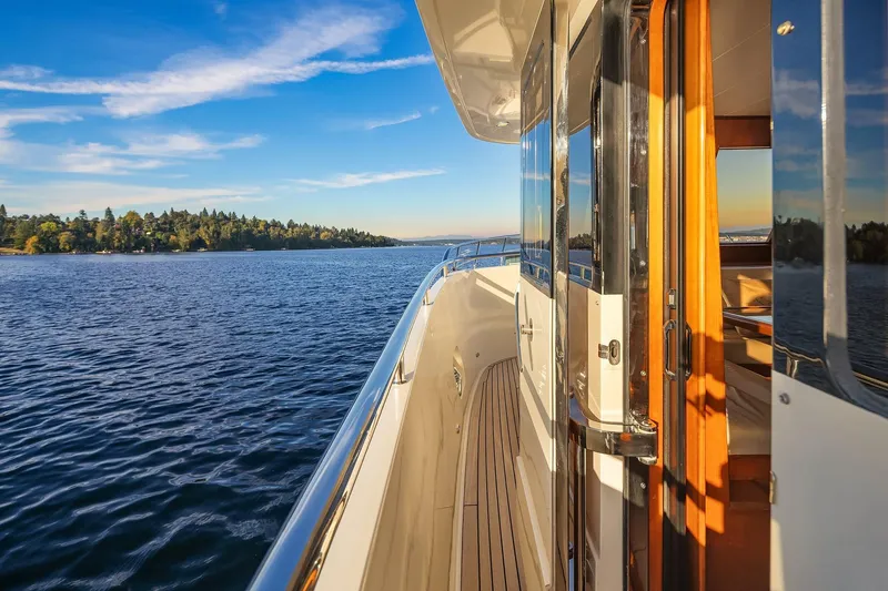 Slide: The Image of 2014 Hampton 720 Skylounge LRC yacht cruising on serene blue waters at sunset. - 84