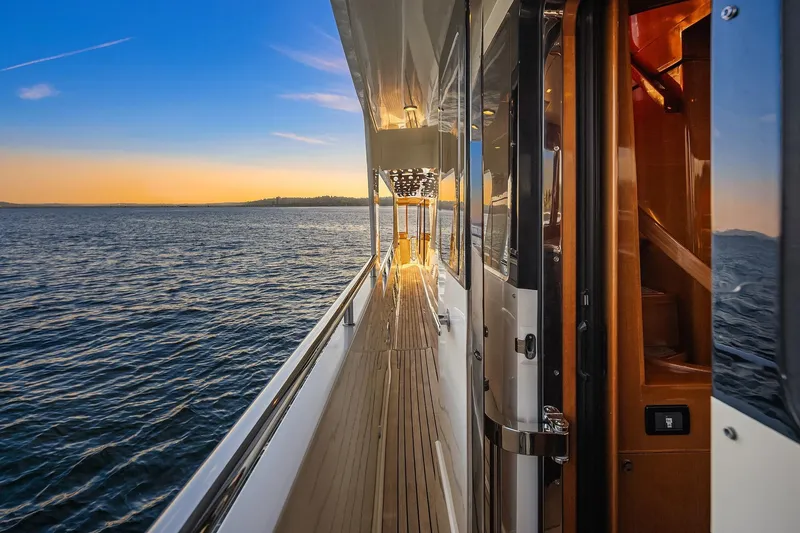 Slide: The Image of Luxurious 2014 Hampton 720 Skylounge LRC yacht cruising on serene waters at sunset. - 85