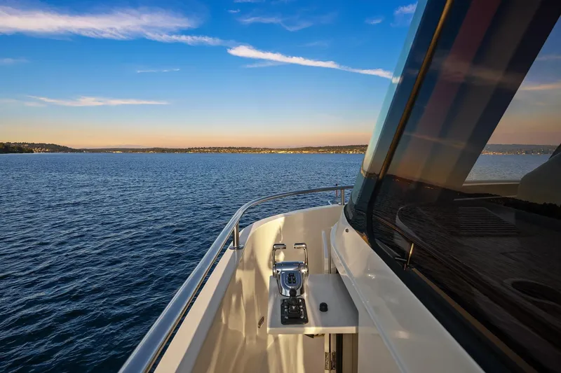 Slide: The Image of 2014 Hampton 720 Skylounge LRC yacht cruising on serene waters at sunset. - 87