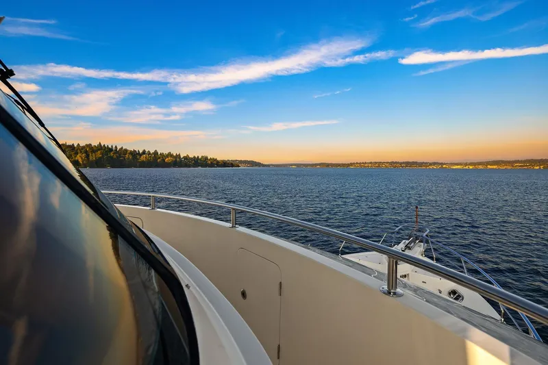 Slide: The Image of Luxurious 2014 Hampton 720 Skylounge LRC yacht on serene water at sunset. - 92