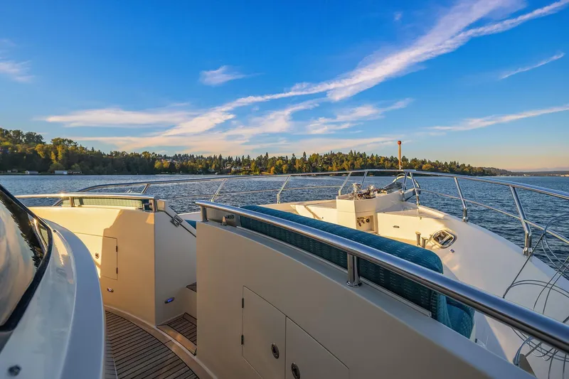 Slide: The Image of Luxurious 2014 Hampton 720 Skylounge LRC yacht on serene water at sunset. - 93
