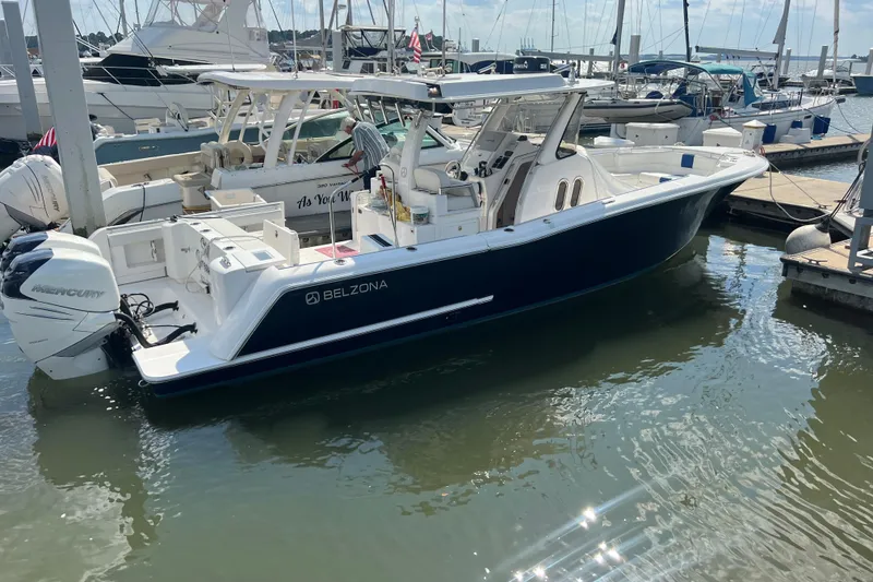 Slide: The Image of 2017 Belzona 325 Center Console with twin Mercury 300 engines docked in water. - 11