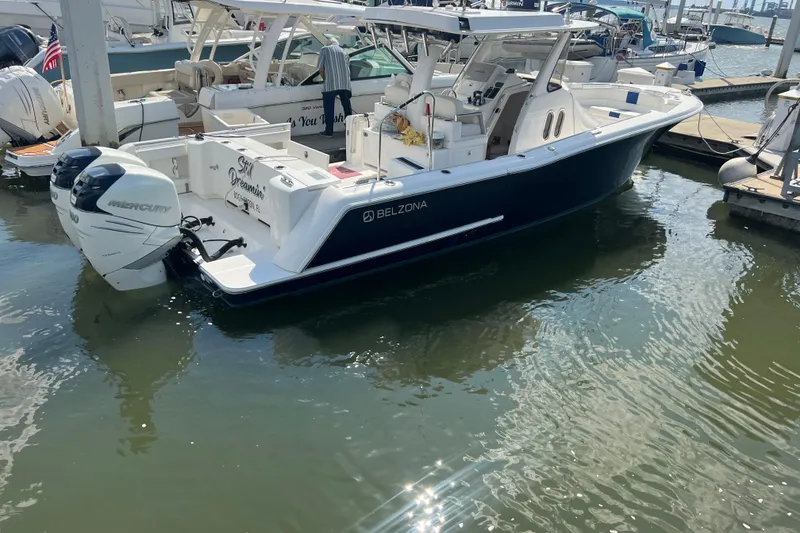 Slide: The Image of 2017 Belzona 325 Center Console boat with sleek design and logo. - 12
