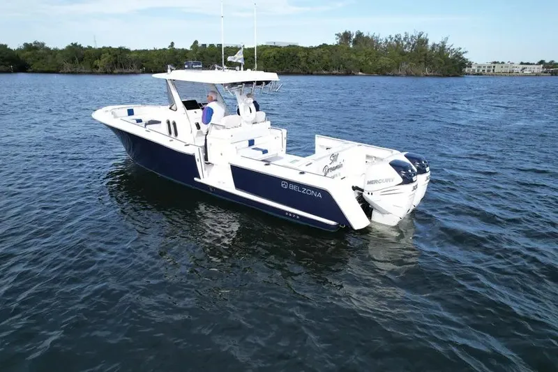 Slide: The Image of 2017 Belzona 325 Center Console boat on water near urban skyline. - 18