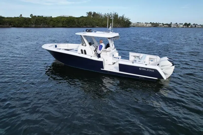 Slide: The Image of 2017 Belzona 325 Center Console boat on calm water, featuring dual Mercury engines. - 19