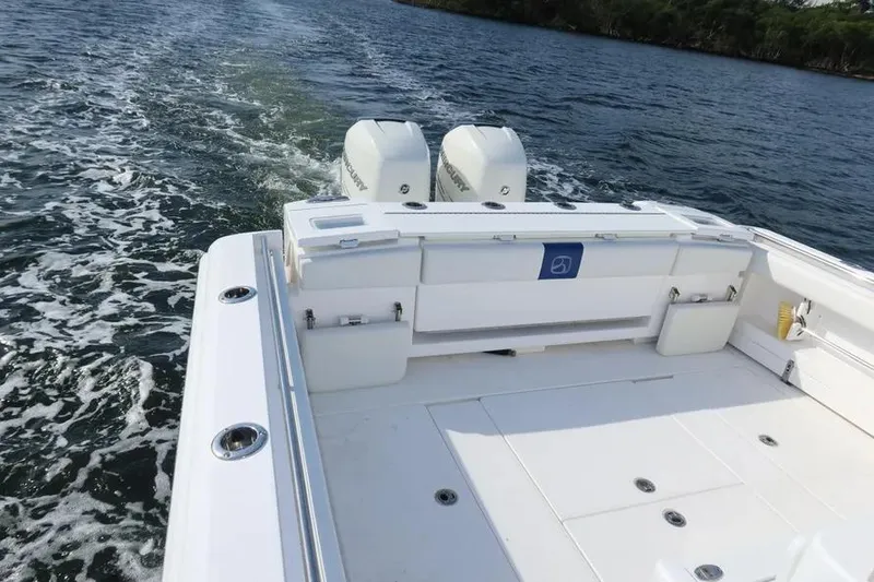 Slide: The Image of 2017 Belzona 325 Center Console boat with twin engines on open water. - 21