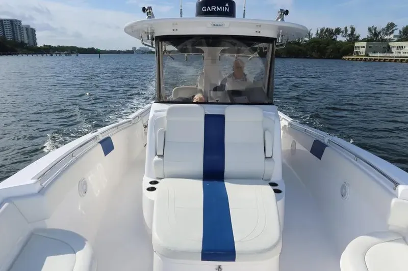 Slide: The Image of 2017 Belzona 325 Center Console boat cruising on a scenic waterway. - 22