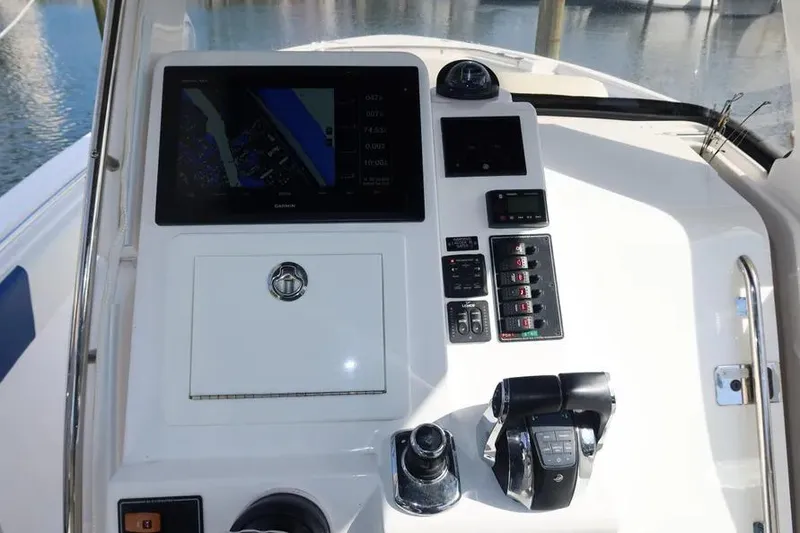 Slide: The Image of 2017 Belzona 325 Center Console dashboard with navigation and control panel. - 24