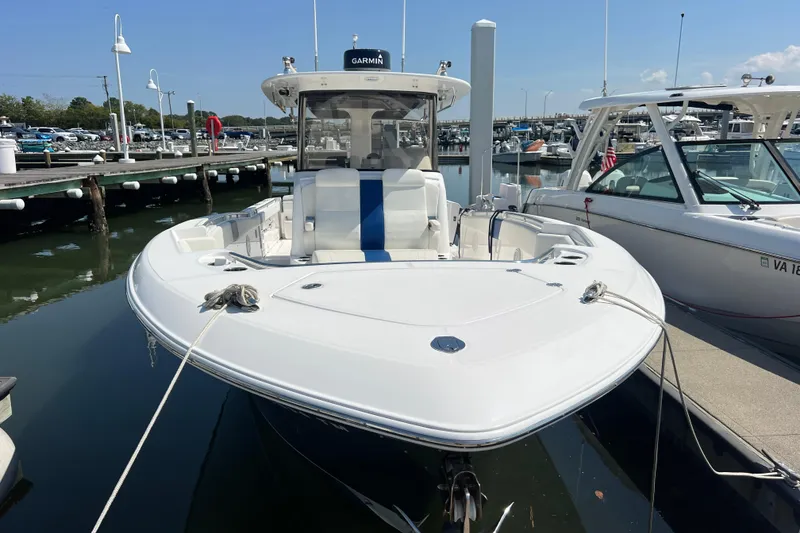 Slide: The Image of 2017 Belzona 325 Center Console boat docked at marina, front view. - 26