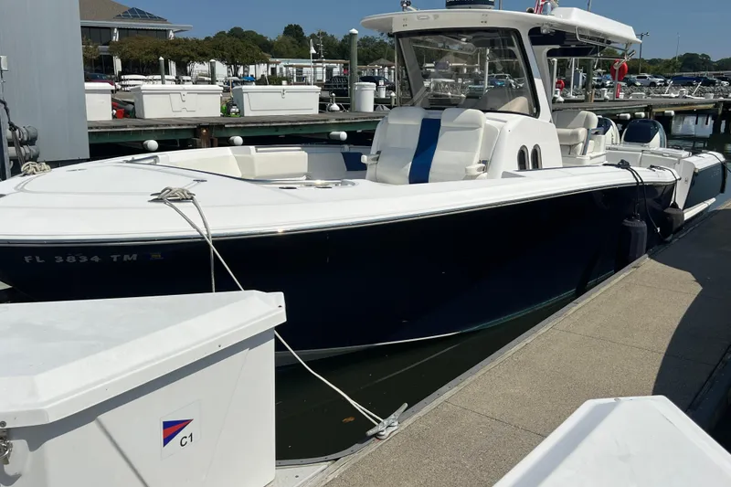 Slide: The Image of 2017 Belzona 325 Center Console boat docked at marina, side view. - 28
