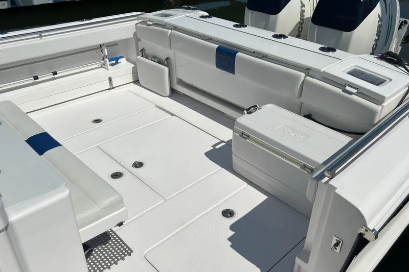 Slide: The Image of 2017 Belzona 325 Center Console boat interior with seating and storage compartments. - 31