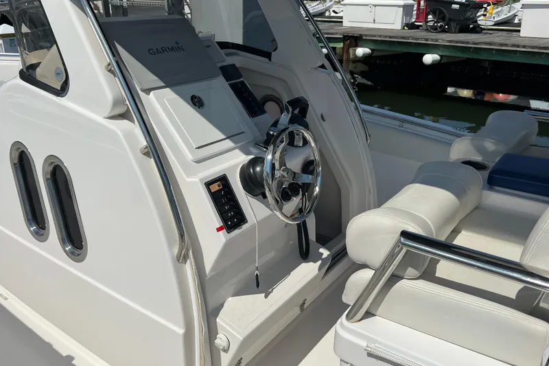 Slide: The Image of 2017 Belzona 325 Center Console boat interior with steering wheel and seating. - 32