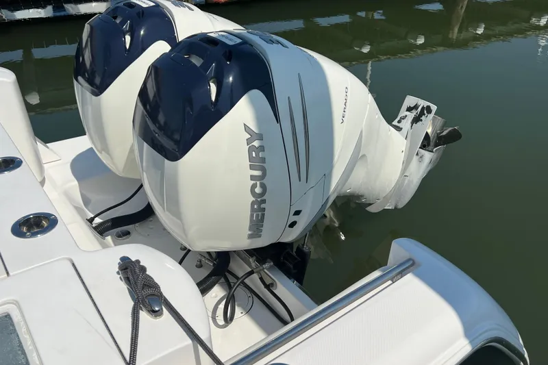 Slide: The Image of 2017 Belzona 325 Center Console with twin Mercury outboard engines on calm water. - 33