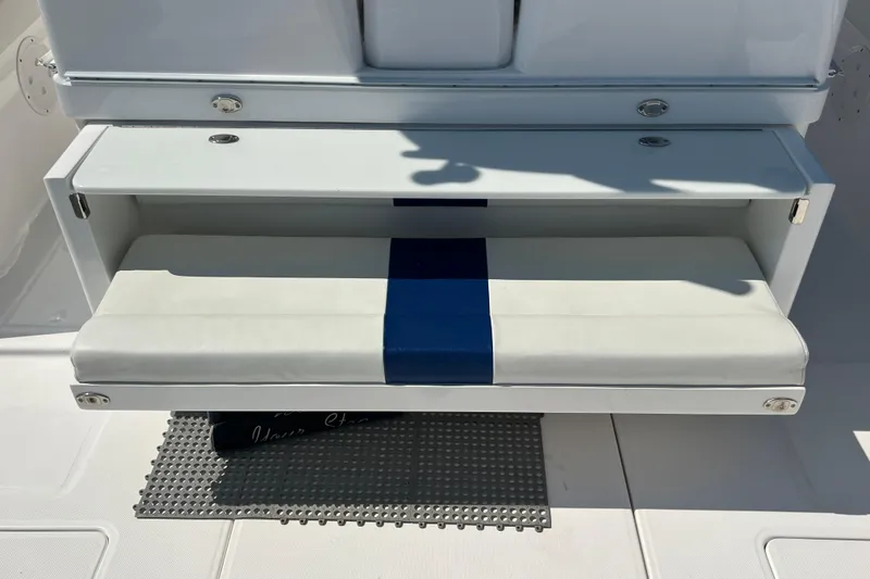Slide: The Image of 2017 Belzona 325 Center Console boat seat with blue and white cushion. - 34