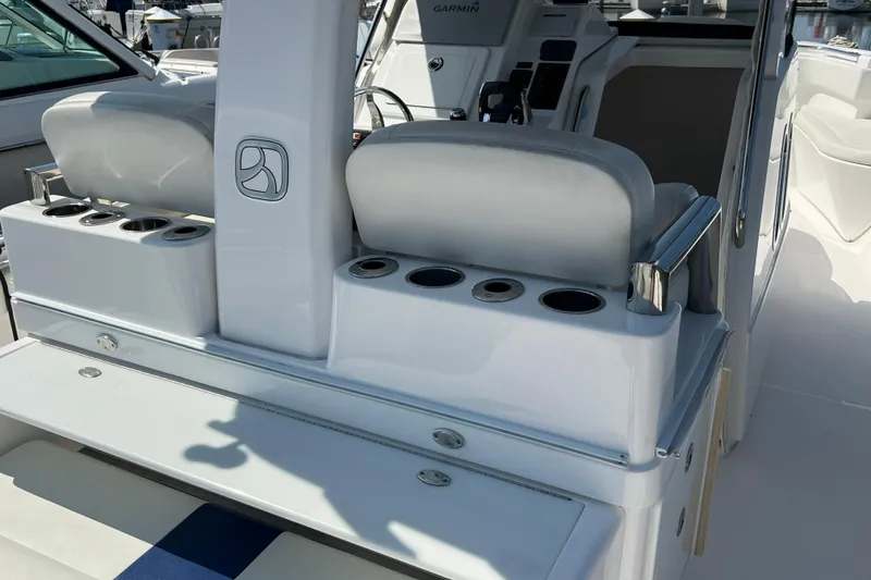 Slide: The Image of 2017 Belzona 325 Center Console boat interior with seating and cup holders. - 35