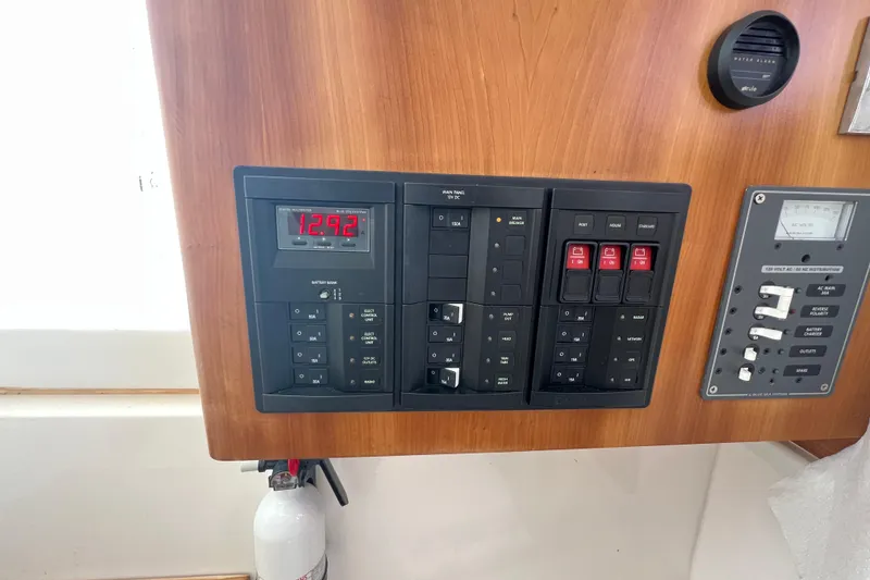 Slide: The Image of Control panel of a 2017 Belzona 325 Center Console boat with digital display and switches. - 47