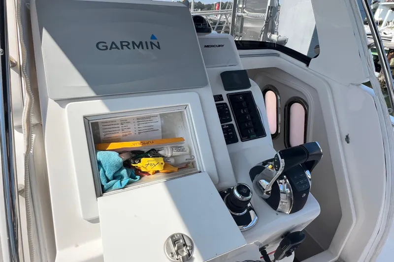 Slide: The Image of 2017 Belzona 325 Center Console helm with Garmin and Mercury controls. - 52