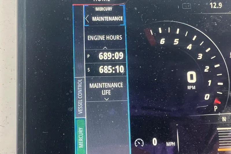 Slide: The Image of Dashboard of a 2017 Belzona 325 Center Console showing engine hours and maintenance details. - 53