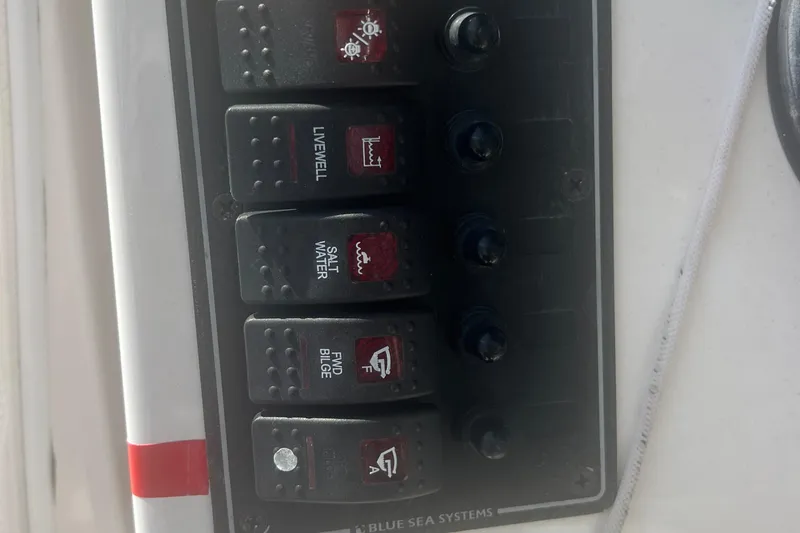 Slide: The Image of Control panel on a 2017 Belzona 325 Center Console boat with labeled switches. - 55
