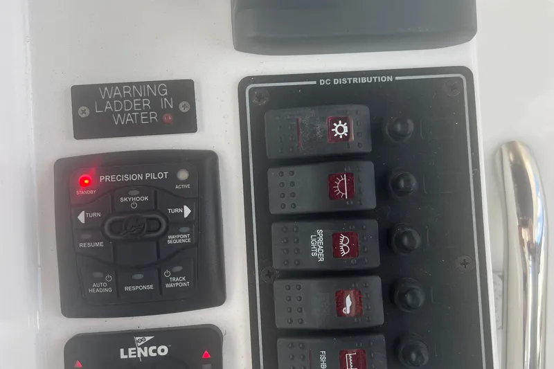Slide: The Image of Control panel of a 2017 Belzona 325 Center Console boat with warning indicators. - 56