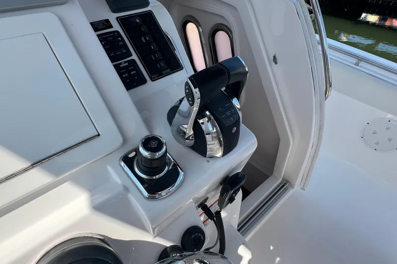 Slide: The Image of Control panel of a 2017 Belzona 325 Center Console boat, featuring modern navigation equipment. - 58