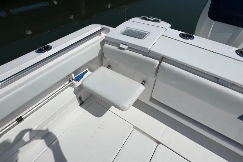 Slide: The Image of 2017 Belzona 325 Center Console boat interior with foldable seat and storage compartments. - 59