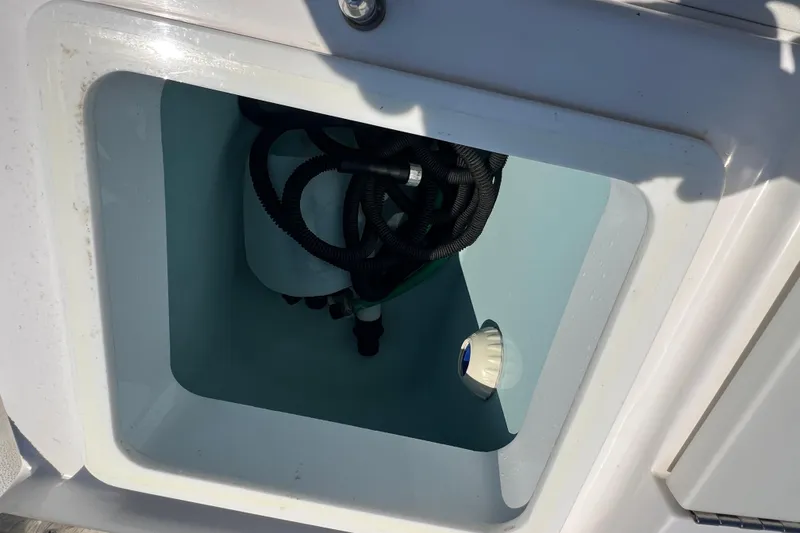 Slide: The Image of Storage compartment on a 2017 Belzona 325 Center Console boat. - 63