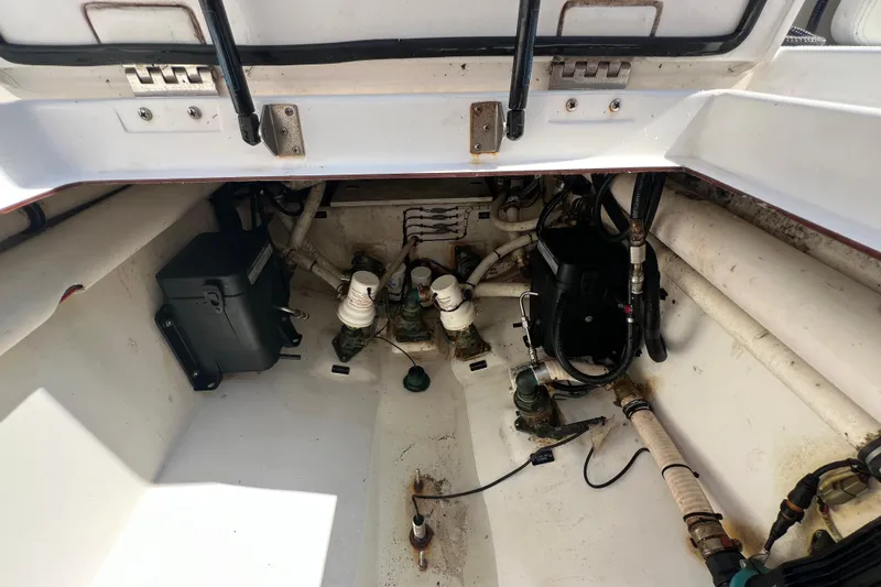 Slide: The Image of 2017 Belzona 325 Center Console boat interior showing mechanical components and wiring. - 72