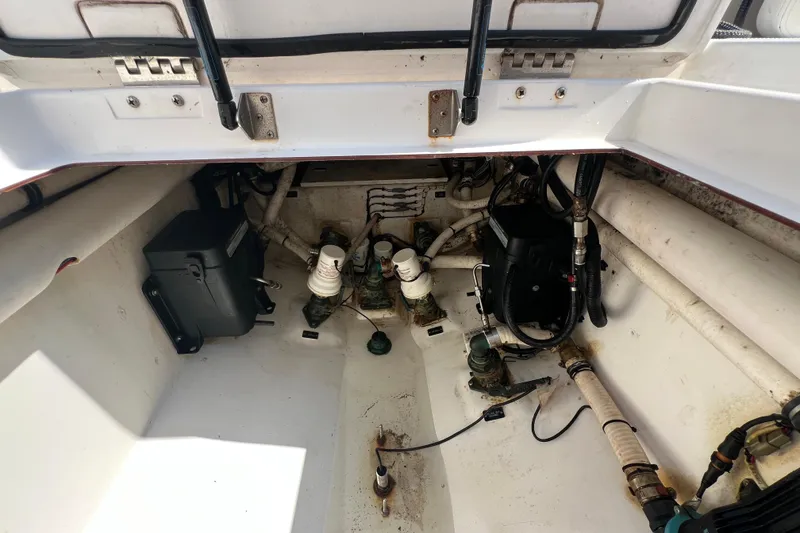 Slide: The Image of 2017 Belzona 325 Center Console boat interior with visible wiring and components. - 73