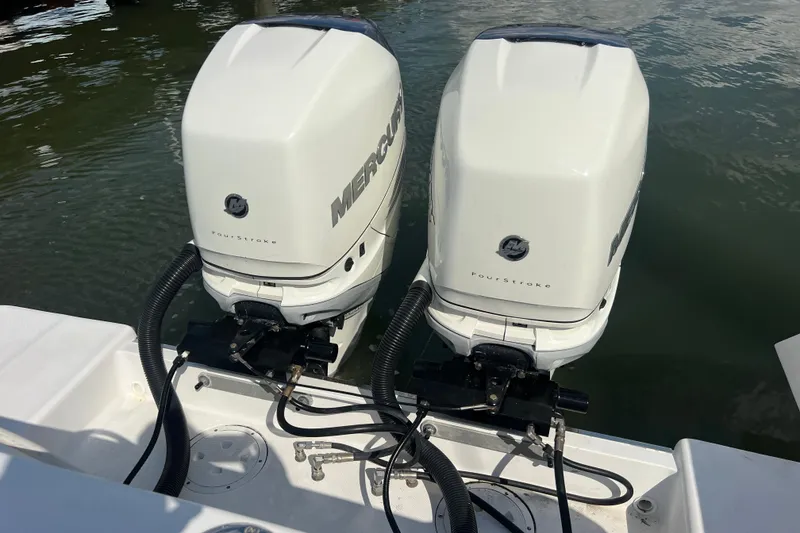 Slide: The Image of 2017 Belzona 325 Center Console boat docked in a marina, surrounded by other vessels. - 8