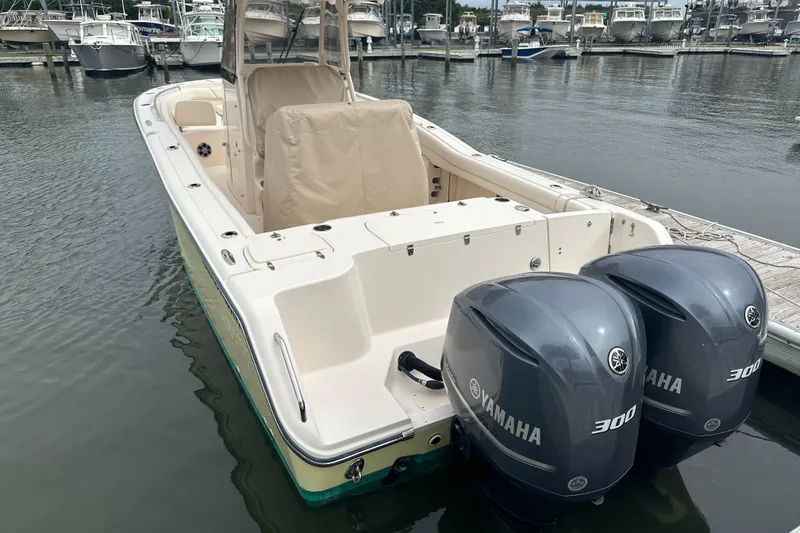 Slide: The Image of 2020 Grady-White Canyon 271 boat with twin Yamaha 300 engines docked at marina. - 11