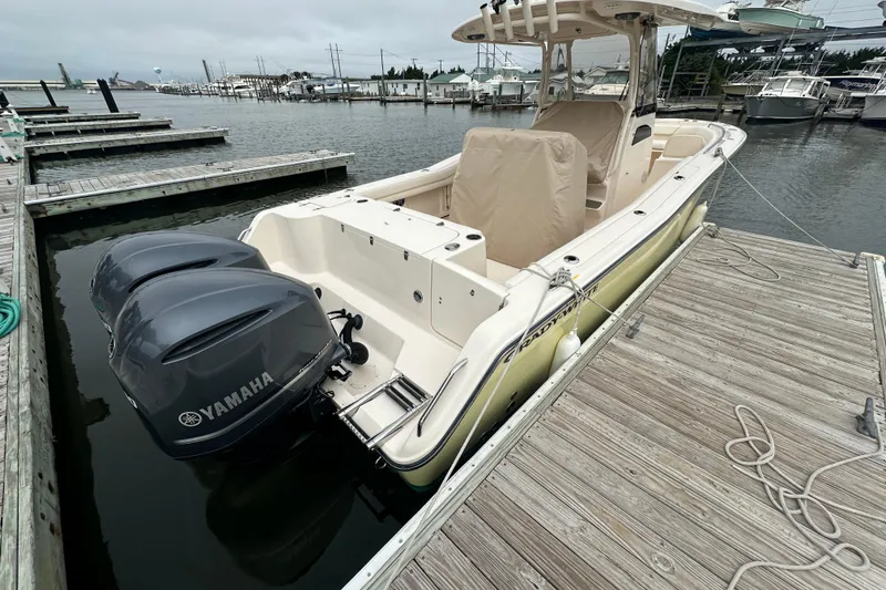 Slide: The Image of 2020 Grady-White Canyon 271 boat docked, featuring dual Yamaha outboard engines. - 13