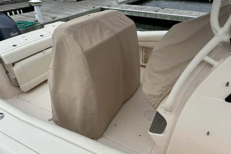 Slide: The Image of 2020 Grady-White Canyon 271 boat interior with covered seats at dock. - 15