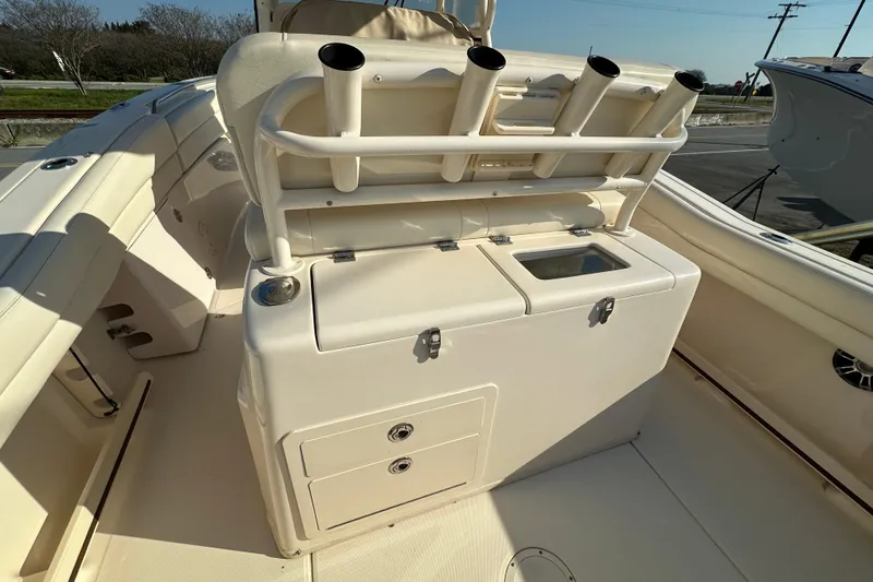 Slide: The Image of 2020 Grady-White Canyon 271 boat interior with rod holders and storage compartments. - 18