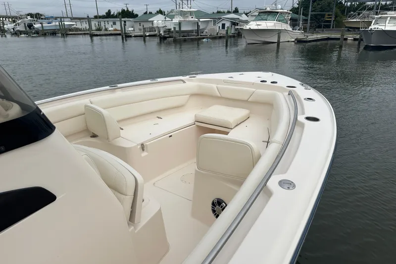 Slide: The Image of 2020 Grady-White Canyon 271 boat with spacious seating, docked in a marina. - 19