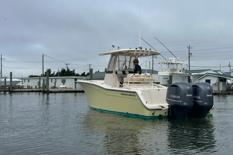 Slide: The Image of 2020 Grady-White Canyon 271 boat with dual Yamaha engines on calm water. - 2