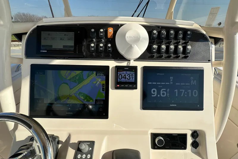 Slide: The Image of Dashboard of 2020 Grady-White Canyon 271 boat with navigation and control systems. - 22