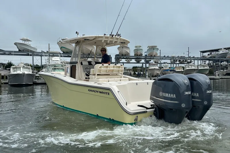 Slide: The Image of 2020 Grady-White Canyon 271 boat with dual Yamaha 300 engines in a marina setting. - 3