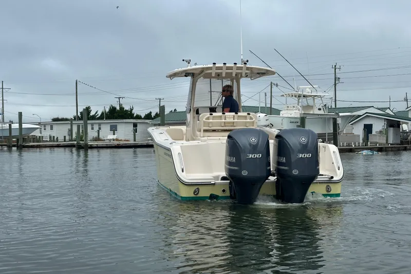 Slide: The Image of 2020 Grady-White Canyon 271 boat with dual Yamaha 300 engines on calm water. - 4
