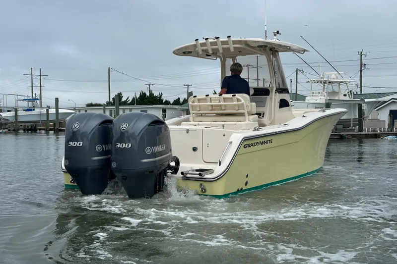 Slide: The Image of 2020 Grady-White Canyon 271 boat with twin Yamaha 300 engines in a marina. - 5