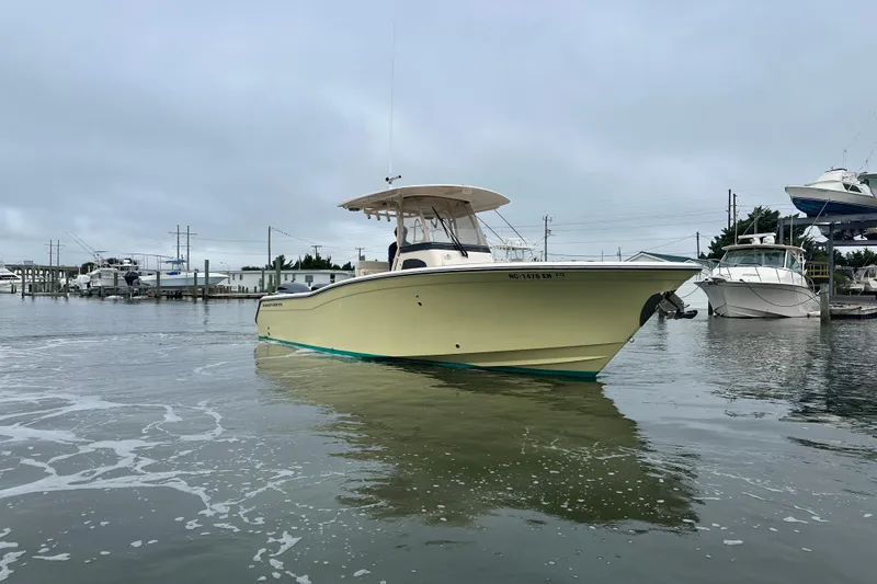Slide: The Image of 2020 Grady-White Canyon 271 boat docked in a marina on a cloudy day. - 8